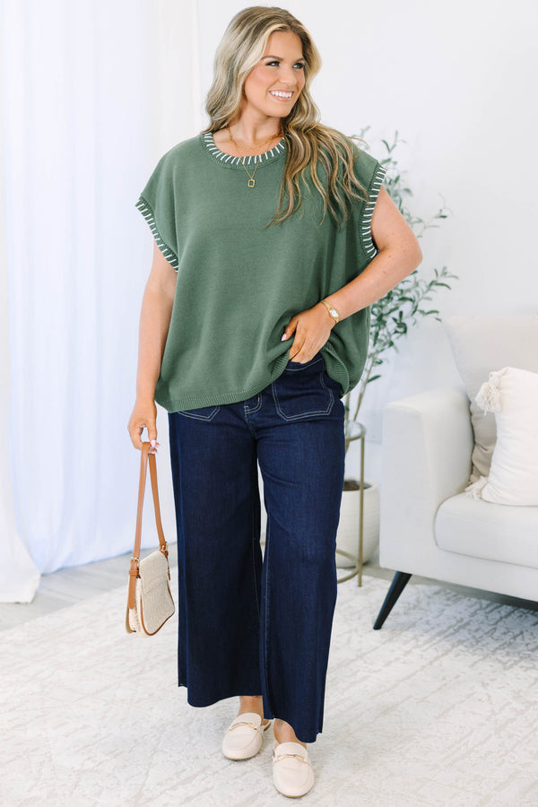 Plus Size green knit short sleeve top with white whipstitch detailing on the neckline and armholes.