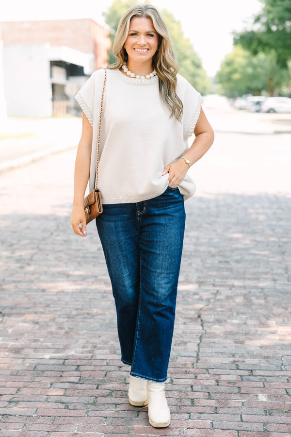 Plus Size sand beige short sleeve knit top with a round neckline and ribbed trim details.