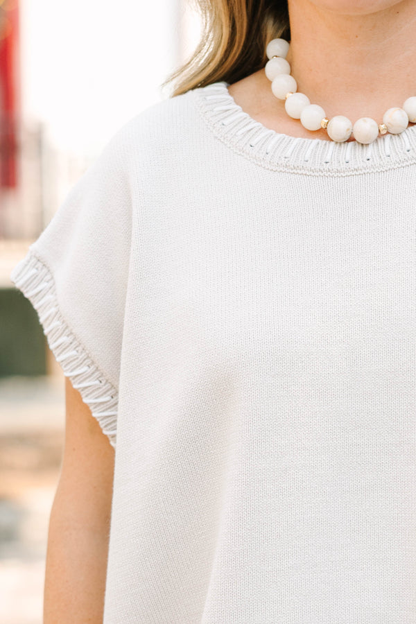 Plus Size sand beige short sleeve knit top with a round neckline and ribbed trim details.