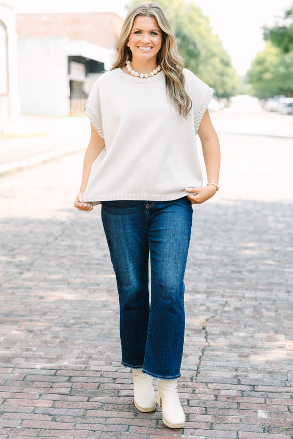 Plus Size sand beige short sleeve knit top with a round neckline and ribbed trim details.
