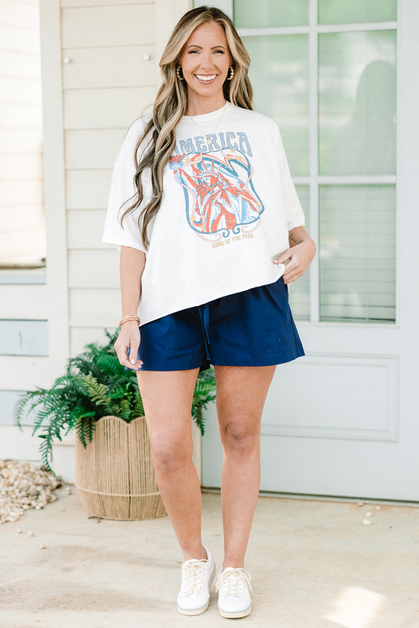 Chic Soul plus size clothing, short-sleeve white drop shoulder vintage washed tee with a high-scoop-neckline and a washed red white and blue graphic with lettering stating 