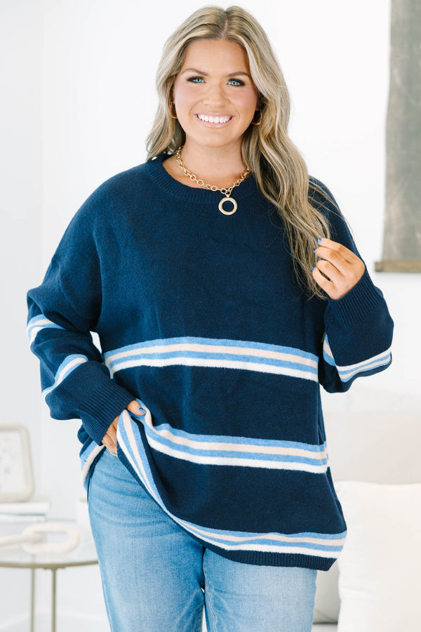 Plus Size navy blue crewneck sweater with horizontal light blue and white stripes and long sleeves.