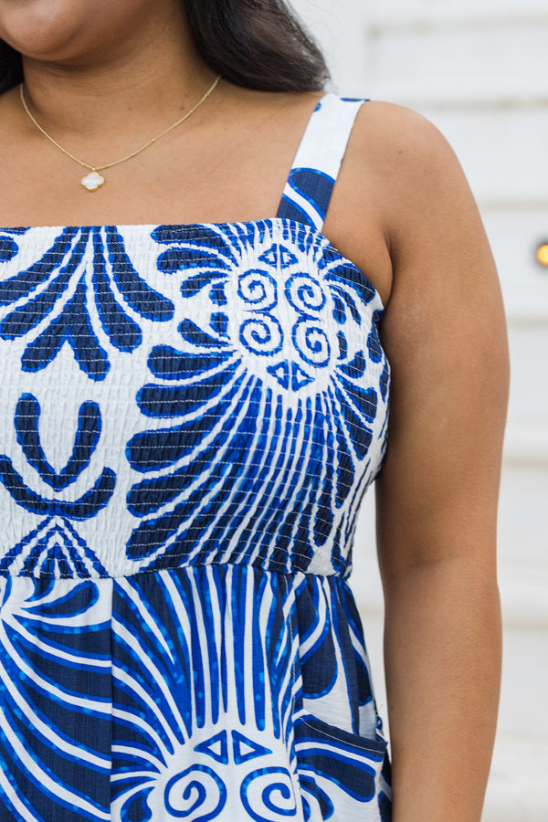 Chic Soul plus size clothing, blue sleeveless jumpsuit with smocked detailing on the chest area and a blue palm abstract pattern throughout