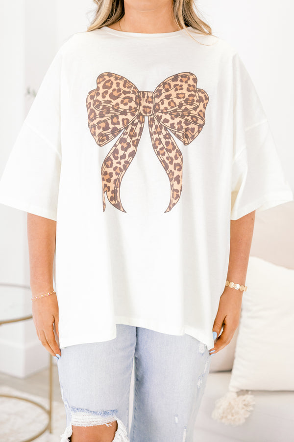Chic Soul plus size clothing, ivory short sleeve graphic tee with a brown leopard bow graphic on the center of the tee 
