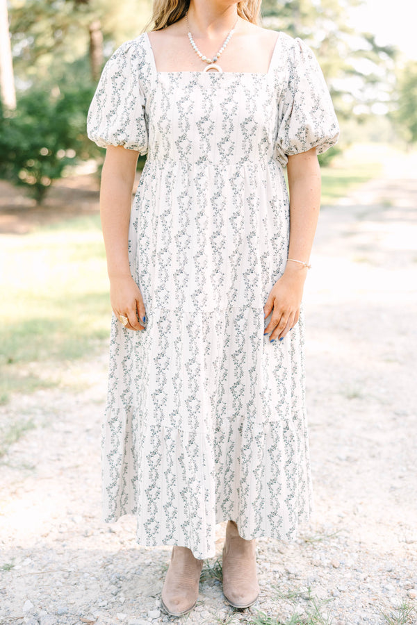 Plus size brown floral maxi dress with puff sleeves and a flowy tiered skirt in 100% cotton.