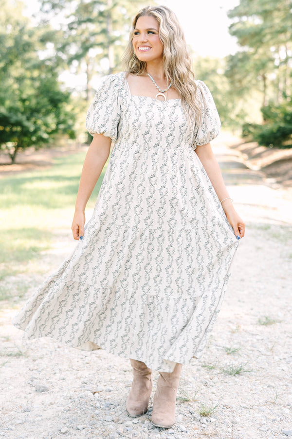 Plus size brown floral maxi dress with puff sleeves and a flowy tiered skirt in 100% cotton.