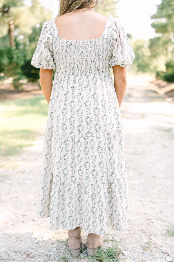 Plus size brown floral maxi dress with puff sleeves and a flowy tiered skirt in 100% cotton.