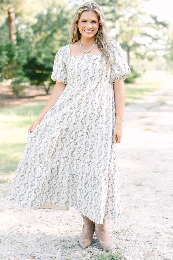 Plus size brown floral maxi dress with puff sleeves and a flowy tiered skirt in 100% cotton.
