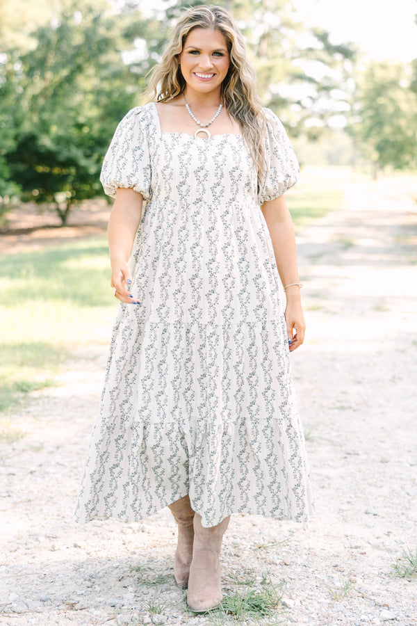 Plus size brown floral maxi dress with puff sleeves and a flowy tiered skirt in 100% cotton.