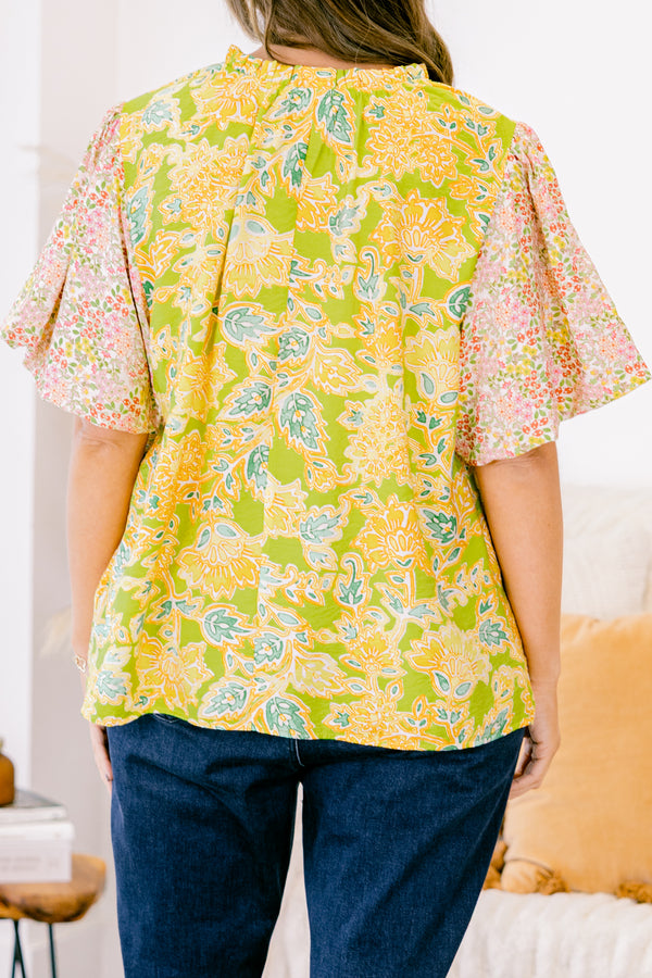 Plus Size green top with abstract print bodice and contrast floral elastic puff sleeves.