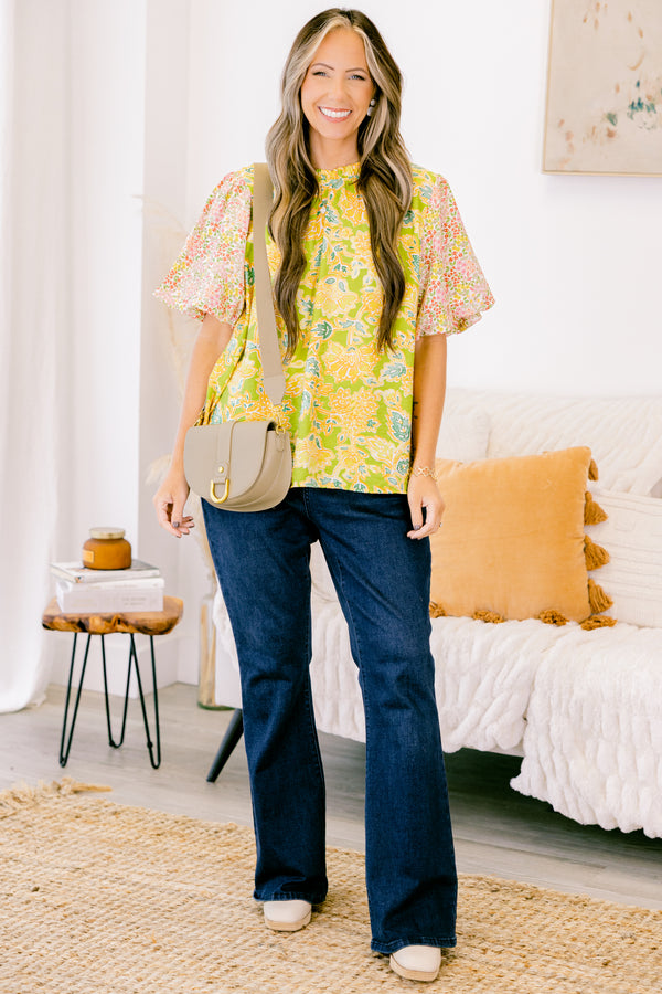 Plus Size green top with abstract print bodice and contrast floral elastic puff sleeves.