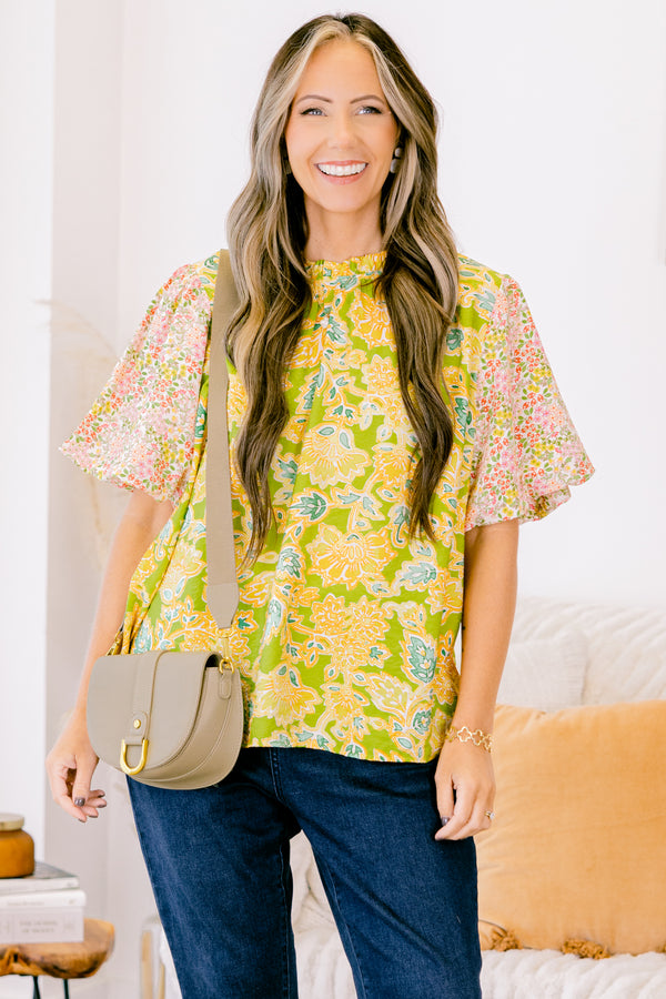 Plus Size green top with abstract print bodice and contrast floral elastic puff sleeves.