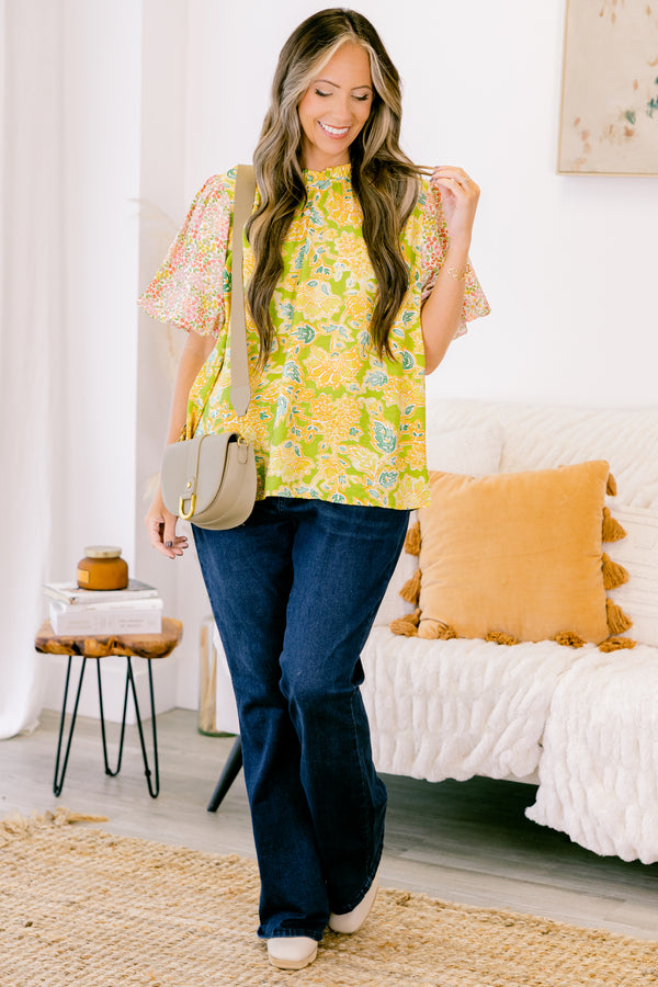 Plus Size green top with abstract print bodice and contrast floral elastic puff sleeves.