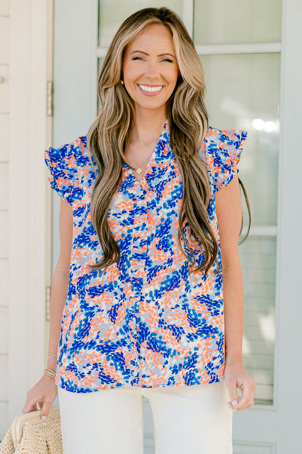 Chic Soul plus size clothing, blue/orange short sleeve abstract dot print blouse with ruffle on sleeves with v neckline and ruffle along center
