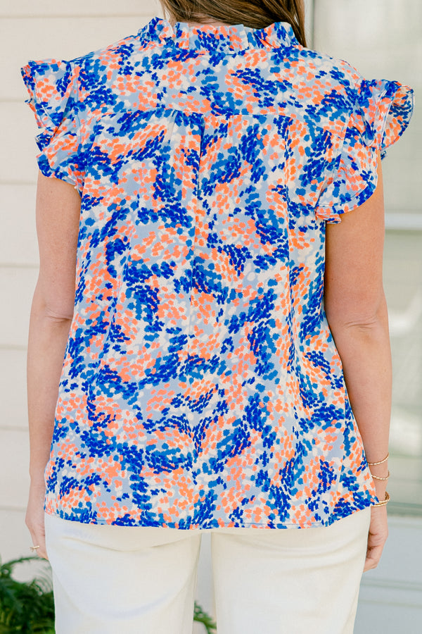Chic Soul plus size clothing, blue/orange short sleeve abstract dot print blouse with ruffle on sleeves with v neckline and ruffle along center
