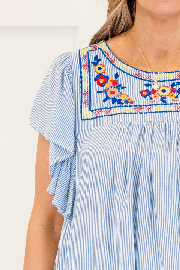 Chic Soul plus size clothing, short-flutter-sleeve denim blue flowy top with a high-scoop-neckline and a multi-colored embroidered floral pattern along the neckline 