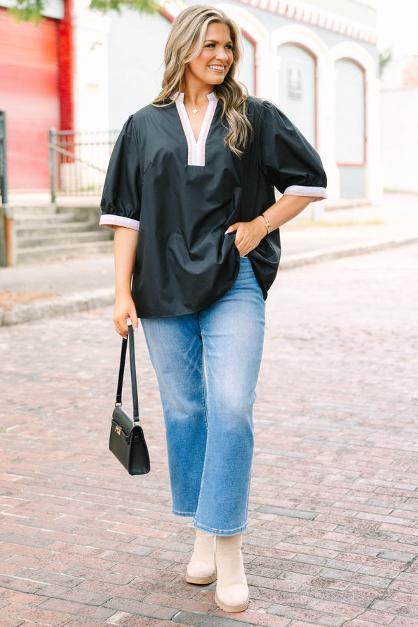 Plus Size black puff-sleeve top with a split v-neckline and cream and tan contrast trim.