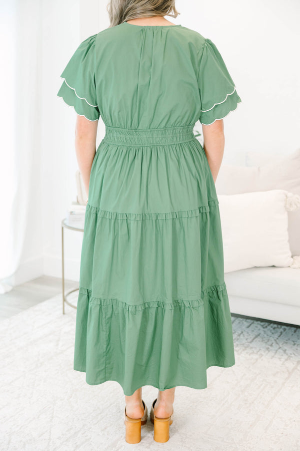 Plus Size olive tiered midi dress with a v-neckline, cinched waist, and scalloped white-piped sleeves.