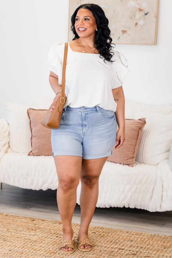 Chic Soul Plus size clothing, light wash jean shorts with front and back pockets as well as cuffs at the end of each short leg 

