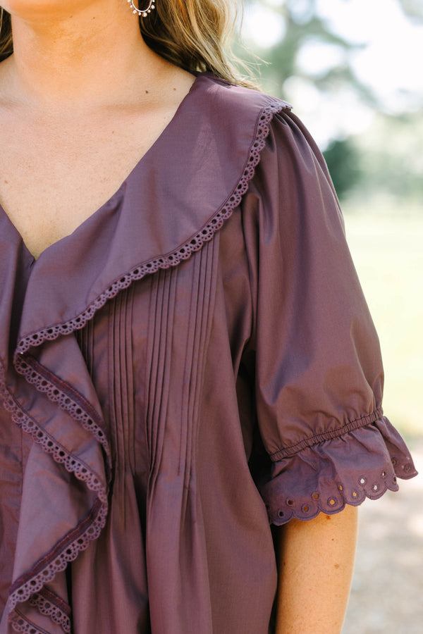 Plus Size brown top with ruffled V-neckline, eyelet trim, button front, and pleated bodice details.