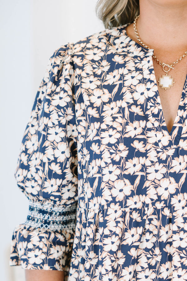 Plus Size black floral tiered midi dress with a V-neckline and three-quarter length puff sleeves.