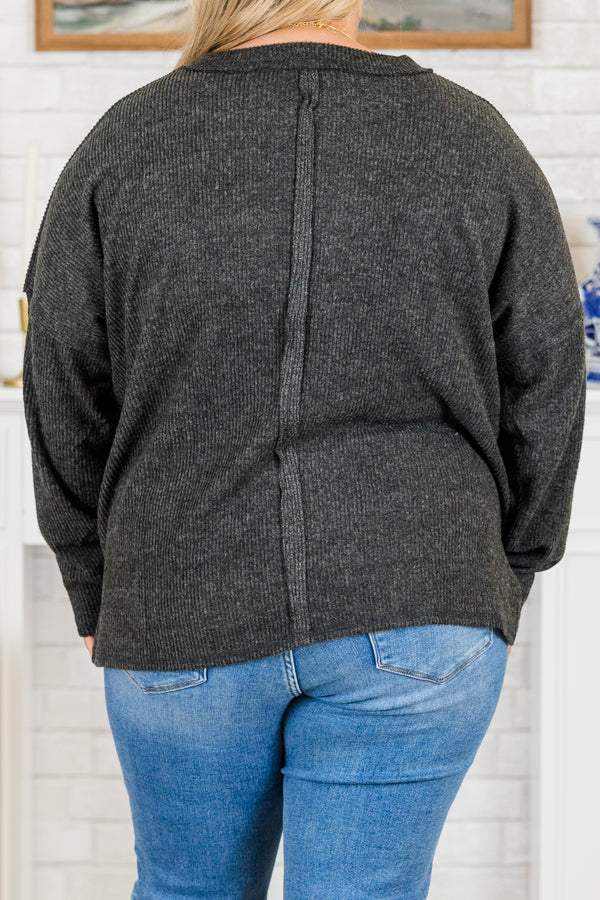 Plus Size black ribbed brushed hacci sweater with a crew neck, chest pocket, and side slits.