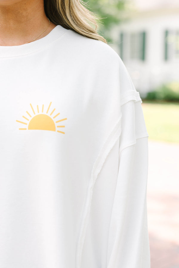 Plus Size ivory crew neck sweatshirt with a yellow sun graphic and frayed denim shorts.
