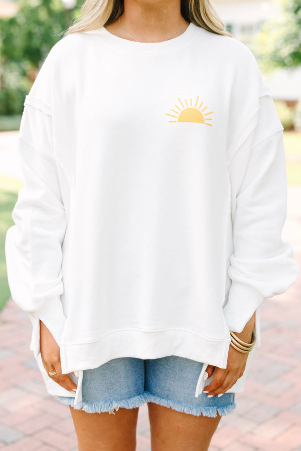 Plus Size ivory crew neck sweatshirt with a yellow sun graphic and frayed denim shorts.