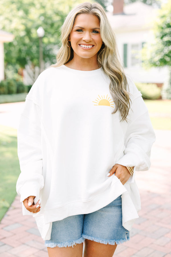 Plus Size ivory crew neck sweatshirt with a yellow sun graphic and frayed denim shorts.
