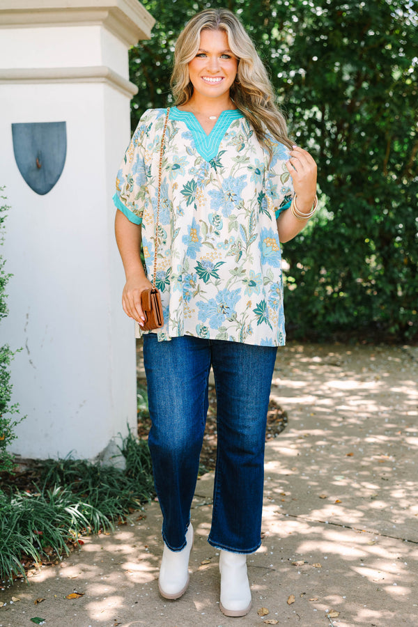 Plus size top in green floral cotton with a flowy fit and V-neckline.