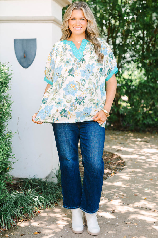 Plus size top in green floral cotton with a flowy fit and V-neckline.