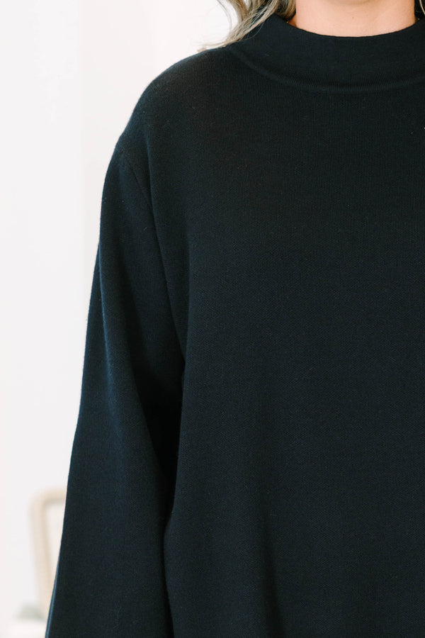 Plus Size black oversized knit sweater with a mock neckline and wide long sleeves.
