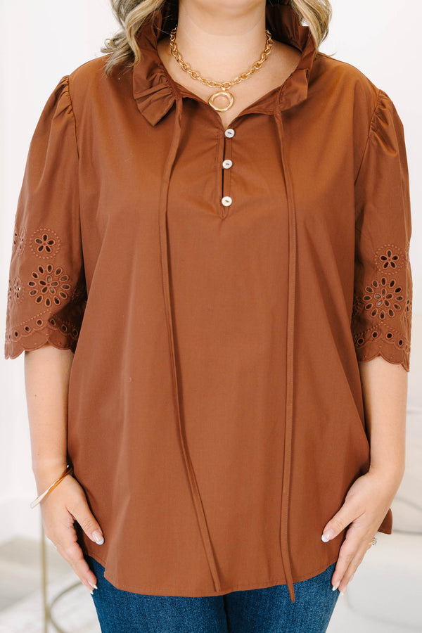 Plus Size brown short sleeve top with eyelet embroidery on the sleeves and a button-up neckline.