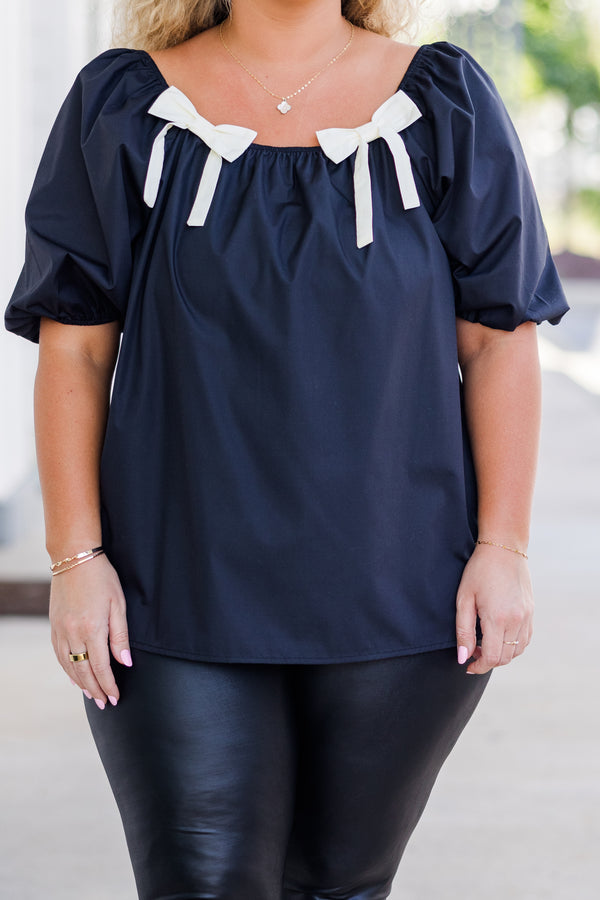 Chic Soul plus size clothing, short-sleeve black top with smocked scoop-neckline and puffed sleeves with two white bows on neckline