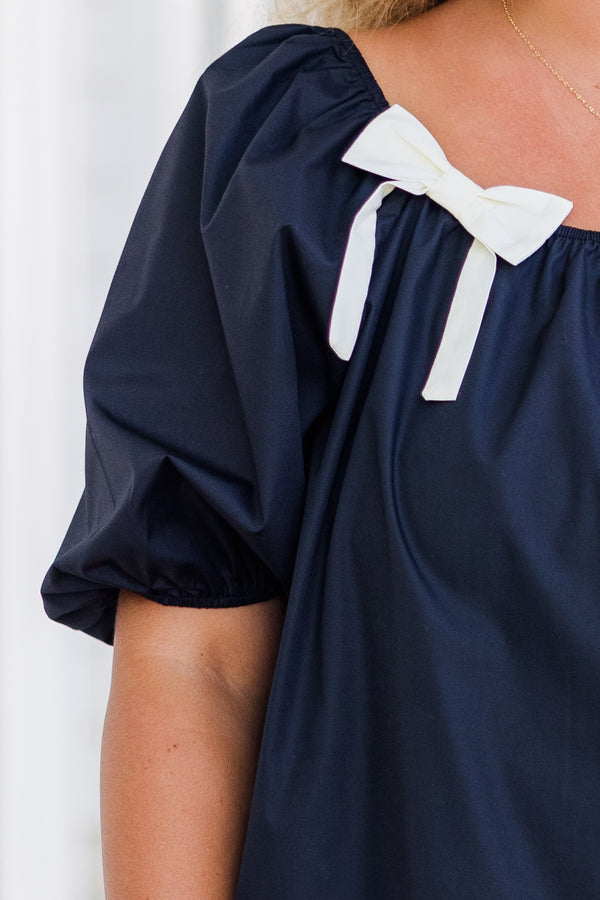 Chic Soul plus size clothing, short-sleeve black top with smocked scoop-neckline and puffed sleeves with two white bows on neckline