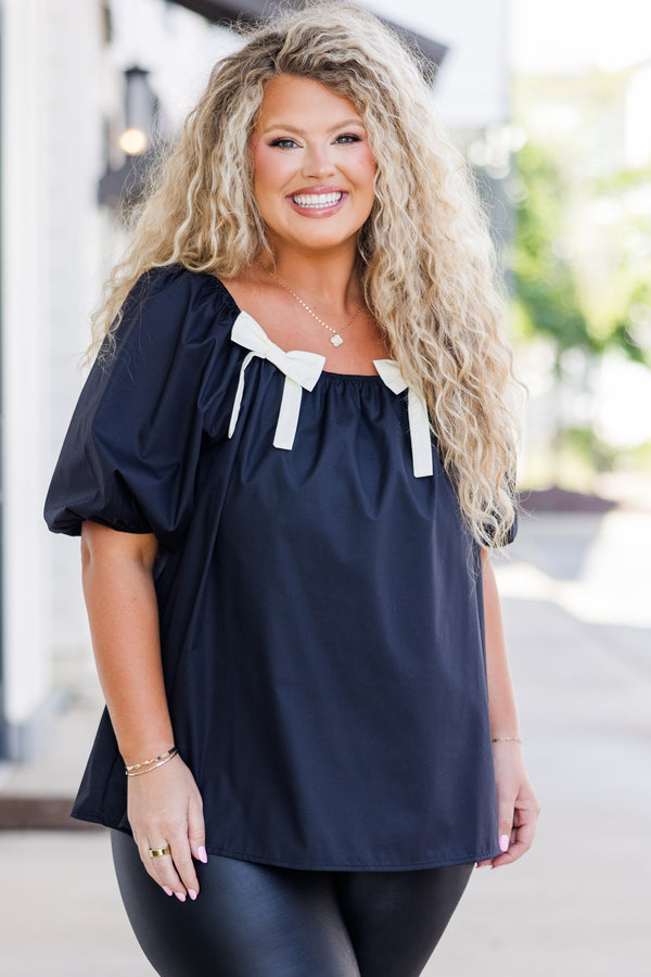 Chic Soul plus size clothing, short-sleeve black top with smocked scoop-neckline and puffed sleeves with two white bows on neckline