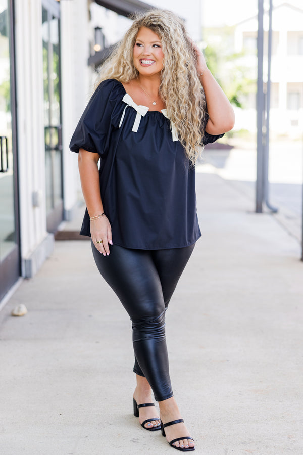 Chic Soul plus size clothing, short-sleeve black top with smocked scoop-neckline and puffed sleeves with two white bows on neckline