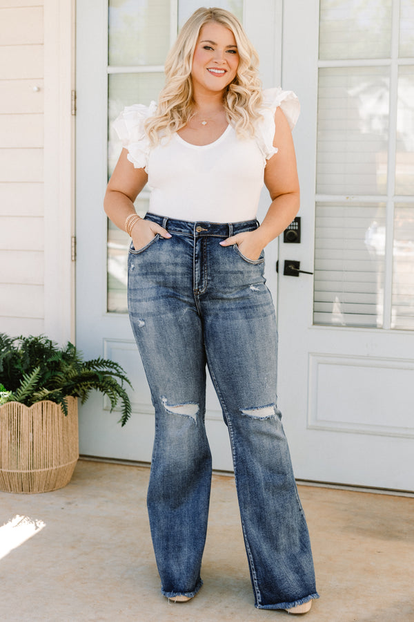 Chic Soul plus size clothing, high-waisted dark wash bootcut denim blue jeans with a subtle distress on the knees and fraying along the seams