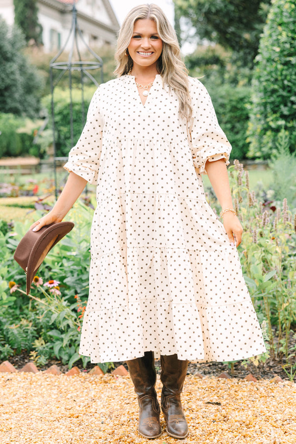 Plus Size cream tiered midi dress with brown polka dots, a V-neckline, and elbow-length sleeves.