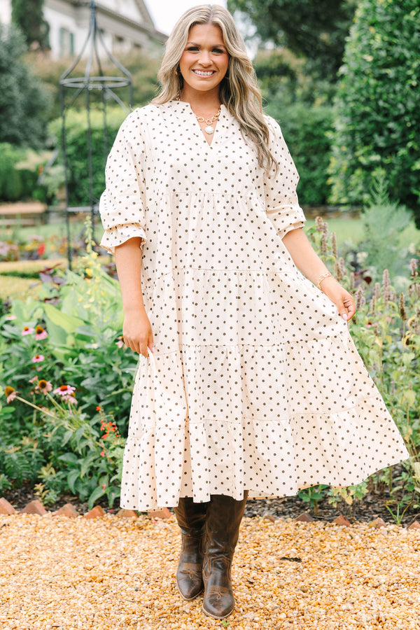 Plus Size cream tiered midi dress with brown polka dots, a V-neckline, and elbow-length sleeves.