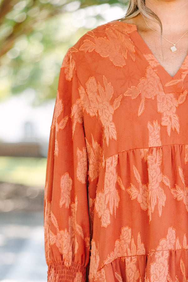Plus Size orange tiered midi dress with a floral jacquard pattern, V-neckline, and 3/4 sleeves.