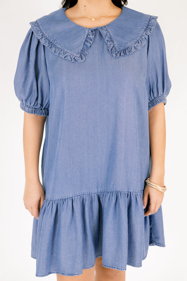 Chic Soul plus size clothing, Denim knee length dress with bubble sleeves and a bib collar that has ruffle detailing going along the edge of the bib as well as a ruffle detail on the bottom tier of the dress 
