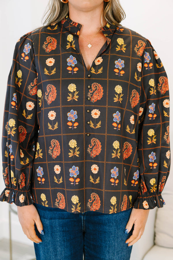 Plus size black cotton blouse with floral paisley print, flowy fit, and puff sleeves.