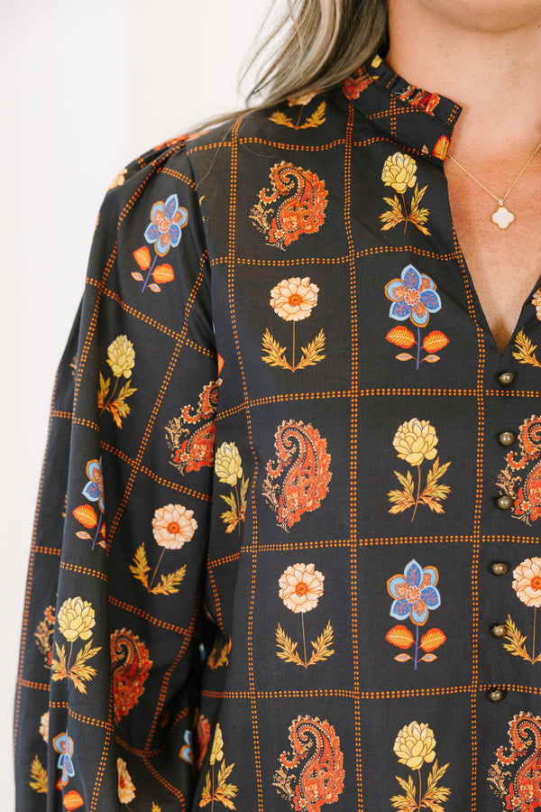 Plus size black cotton blouse with floral paisley print, flowy fit, and puff sleeves.