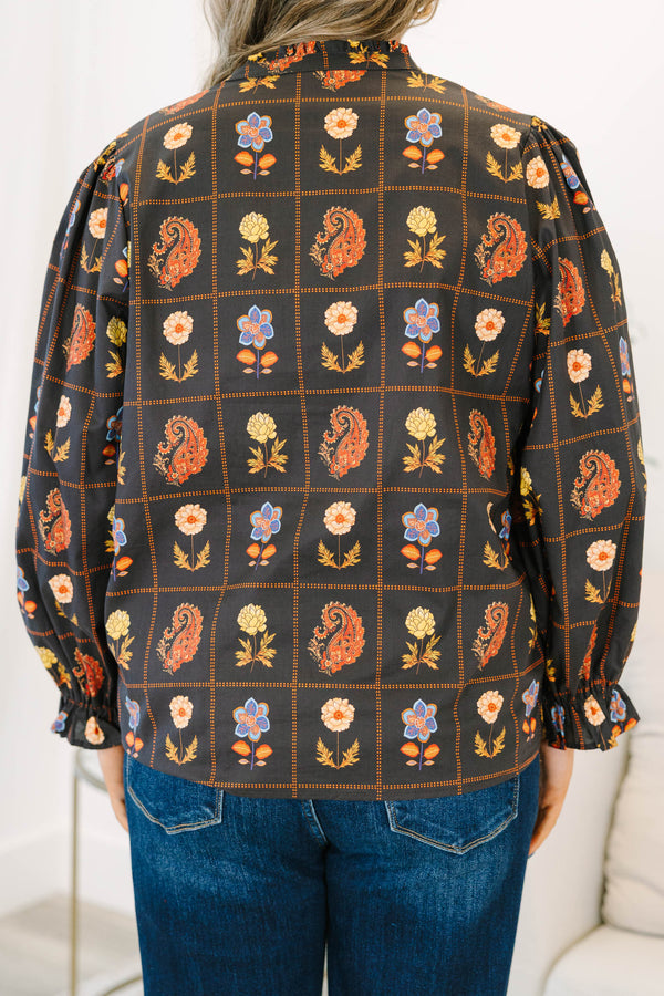 Plus size black cotton blouse with floral paisley print, flowy fit, and puff sleeves.