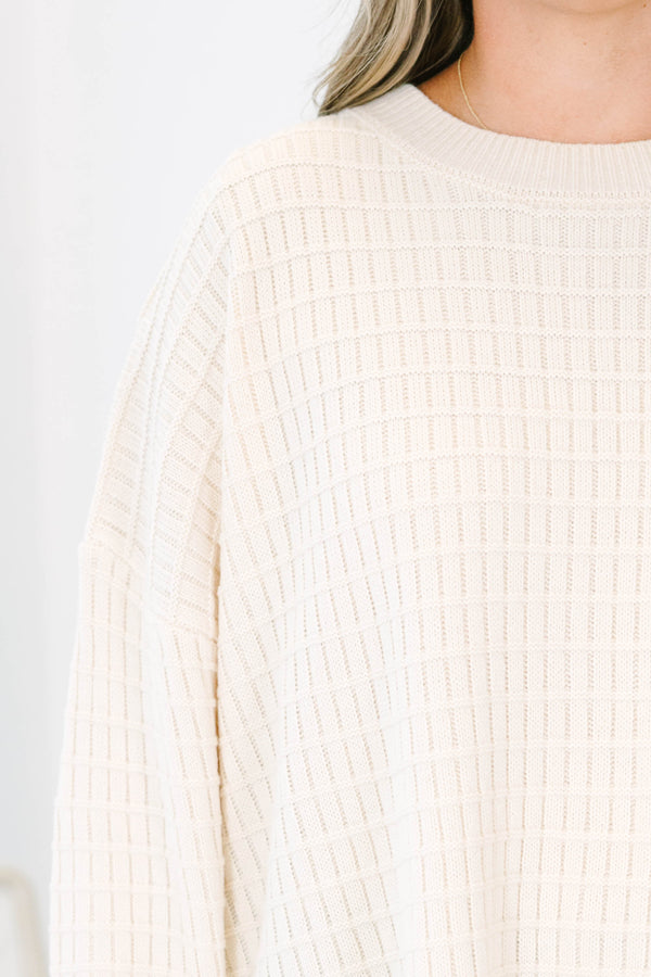 Plus size cream oversized knit sweater with a textured grid pattern and side slits.