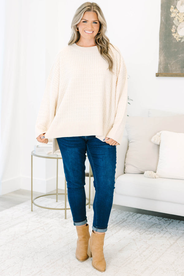 Plus size cream oversized knit sweater with a textured grid pattern and side slits.