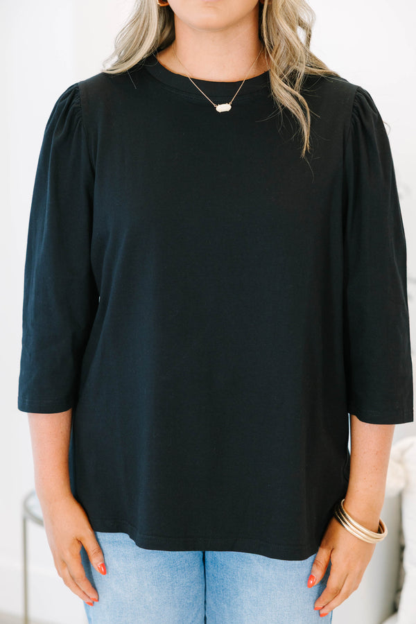 Plus Size black crew neck top with three quarter sleeves and a relaxed fit.