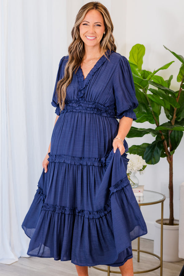 Plus Size navy maxi dress with ruffle trim, a tiered skirt, and elastic bubble sleeves.