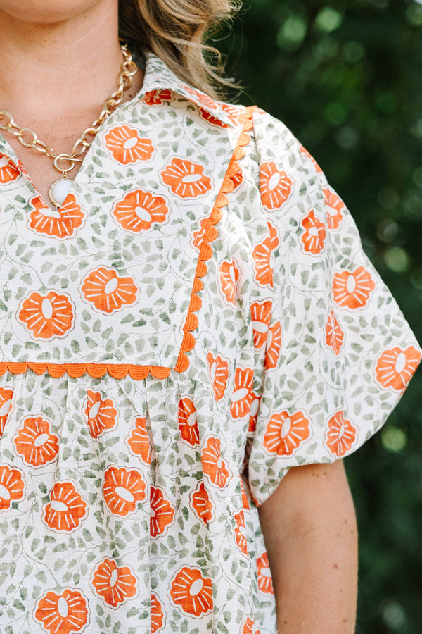 Plus Size floral babydoll top in burnt orange and green with a square yoke and short puff sleeves.